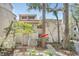 The exterior of a two-story condo building with a tile roof with lovely surrounding landscaping at 1000 Winderley Pl # 143, Maitland, FL 32751