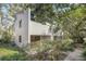 Exterior view of home featuring a red tile roof and beautiful surrounding foliage at 1000 Winderley Pl # 143, Maitland, FL 32751