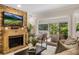 Cozy living room featuring a stone fireplace, comfortable seating, and sliding glass doors to outdoor space at 1000 Winderley Pl # 143, Maitland, FL 32751