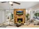 Inviting living room showcasing a stone fireplace with a mounted TV and views into the adjacent rooms at 1000 Winderley Pl # 143, Maitland, FL 32751
