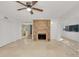 Open living room with a fireplace, tile flooring, ceiling fans, and an open concept design at 1000 Winderley Pl # 143, Maitland, FL 32751