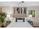 Well-lit main bedroom with a decorative painting, bedside lamps, and large, comfortable bed at 1000 Winderley Pl # 143, Maitland, FL 32751