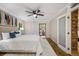 Bright main bedroom featuring a ceiling fan, comfortable bedding, and access to the sunroom at 1000 Winderley Pl # 143, Maitland, FL 32751