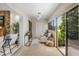 Bright sunroom with tiled floors, comfortable seating, and large windows offering serene views at 1000 Winderley Pl # 143, Maitland, FL 32751