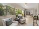 Serene sunroom with tile floors, comfortable seating, and views of the backyard and kitchen at 1000 Winderley Pl # 143, Maitland, FL 32751