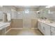 Luxurious bathroom with separate vanities, a spacious shower with dual shower heads, and modern fixtures at 10219 Atwater Bay Dr, Winter Garden, FL 34787