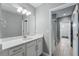 Clean bathroom features neutral paint, quartz countertops, a large mirror, and tiled floors at 10219 Atwater Bay Dr, Winter Garden, FL 34787