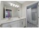 Bathroom features double sink vanity with quartz countertop, a large mirror and tub with shower at 10219 Atwater Bay Dr, Winter Garden, FL 34787