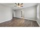 Open bedroom with wood floors, neutral walls, crown molding, ceiling fan, and an ensuite bathroom at 10219 Atwater Bay Dr, Winter Garden, FL 34787
