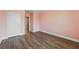 Bedroom with wood floor, pink walls, white door and white trim at 10219 Atwater Bay Dr, Winter Garden, FL 34787