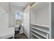 Walk-in closet with built-in shelving and hanging rods, adjacent to a desk area with natural light at 10219 Atwater Bay Dr, Winter Garden, FL 34787