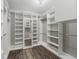Walk-in closet with custom shelving, drawers, and ample storage space for clothing and accessories at 10219 Atwater Bay Dr, Winter Garden, FL 34787