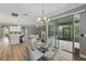 Elegant dining room with modern chandelier and sliding glass doors leading to an outdoor patio at 10219 Atwater Bay Dr, Winter Garden, FL 34787