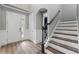 Inviting foyer with staircase, wood flooring, and a view of the home's entrance with natural light at 10219 Atwater Bay Dr, Winter Garden, FL 34787