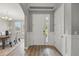 Inviting foyer with white wainscoting, wood floors and an adjacent dining room at 10219 Atwater Bay Dr, Winter Garden, FL 34787