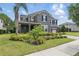 Beautiful home featuring a two-car garage, and beautifully landscaped front yard, shrubbery, and impeccable lawn maintenance at 10219 Atwater Bay Dr, Winter Garden, FL 34787