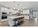 Bright modern kitchen featuring white cabinets, an island with seating, and stainless steel appliances at 10219 Atwater Bay Dr, Winter Garden, FL 34787