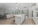 Open-concept kitchen with a large island, stainless steel appliances, and wood flooring at 10219 Atwater Bay Dr, Winter Garden, FL 34787