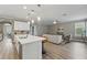 Bright and airy living room featuring an open concept design, seamlessly connecting the kitchen and living area at 10219 Atwater Bay Dr, Winter Garden, FL 34787