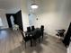 Modern dining area with a glass table and black chairs at 1042 Chamberlin Trl, St Cloud, FL 34772