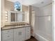 Bathroom with granite countertop, white cabinets and bathtub at 110 Becket Ln, Lake Mary, FL 32746