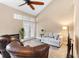 Living room with vaulted ceiling, fireplace, and French doors to patio at 110 Becket Ln, Lake Mary, FL 32746