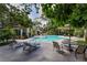 Community pool with lounge chairs and patio tables at 110 Becket Ln, Lake Mary, FL 32746