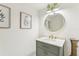 Updated bathroom with a stylish vanity and round mirror at 1120 Portland Ave # 4, Orlando, FL 32803
