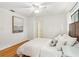 Bedroom with a queen bed, hardwood floors, and large art at 1120 Portland Ave # 4, Orlando, FL 32803