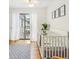 Bright bedroom with crib and access to balcony at 1120 Portland Ave # 4, Orlando, FL 32803