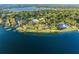 Aerial view of an expansive lakefront estate with sprawling lawns, mature trees, and waterfront access at 11900 Lake Butler Blvd, Windermere, FL 34786