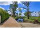 Beautiful backyard featuring lush lawns, trees, water canal and dock, boat ramp, and walkway at 11900 Lake Butler Blvd, Windermere, FL 34786