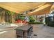 Beautiful backyard with outdoor dining area and shade sails, perfect for entertaining guests at 11900 Lake Butler Blvd, Windermere, FL 34786
