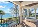 Enjoy the view from this relaxing covered balcony with seating and hot tub at 11900 Lake Butler Blvd, Windermere, FL 34786