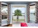 Scenic lake view from the bedroom balcony, framed by colorful curtains and wrought-iron railings at 11900 Lake Butler Blvd, Windermere, FL 34786