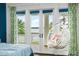 Beautiful waterfront view from a bedroom balcony, featuring a hanging chair for relaxation at 11900 Lake Butler Blvd, Windermere, FL 34786