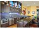 Stylish bar area with granite countertops, stainless steel appliances, and custom display shelving at 11900 Lake Butler Blvd, Windermere, FL 34786