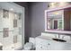 Modern bathroom featuring a glass-enclosed shower with decorative tiles, a vanity, and a stylish mirror at 11900 Lake Butler Blvd, Windermere, FL 34786