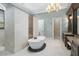 This bathroom is complete with a chandelier, free standing tub, and double vanity sinks at 11900 Lake Butler Blvd, Windermere, FL 34786