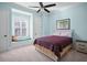 Bright bedroom with a window seat, neutral carpet, and a queen size bed at 11900 Lake Butler Blvd, Windermere, FL 34786
