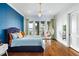 Cozy bedroom with a fun hanging chair and balcony access, offering serene waterfront views at 11900 Lake Butler Blvd, Windermere, FL 34786