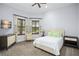 Cozy bedroom featuring a plush bed, two windows with shutters, and a wall-mounted television at 11900 Lake Butler Blvd, Windermere, FL 34786