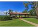 Covered boat house and dock area with a lush lawn, beautiful landscaping, and lake views at 11900 Lake Butler Blvd, Windermere, FL 34786