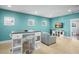 A vibrant bonus room with comfortable seating, a stylish island, and three bright windows at 11900 Lake Butler Blvd, Windermere, FL 34786