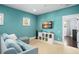 Comfortable bonus room featuring a plush sofa, TV, and natural light from two windows at 11900 Lake Butler Blvd, Windermere, FL 34786