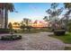 Circular driveway featuring a fountain and beautiful landscaping leading to a lakefront home at 11900 Lake Butler Blvd, Windermere, FL 34786