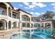 Beautiful home showcasing a custom pool, hot tub and water views at 11900 Lake Butler Blvd, Windermere, FL 34786