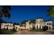 Elegant estate home at twilight, featuring beautiful architecture, lighting, and landscaping at 11900 Lake Butler Blvd, Windermere, FL 34786
