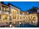Grand waterfront home with a large outdoor entertaining area, balconies, and an infinity pool at 11900 Lake Butler Blvd, Windermere, FL 34786