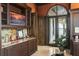 Home office featuring custom cabinetry, a wet bar, and access to an outdoor patio at 11900 Lake Butler Blvd, Windermere, FL 34786